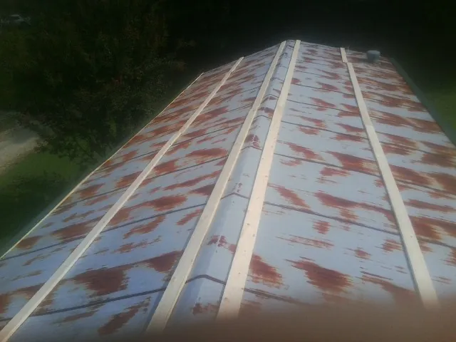 Rusted metal roof panels with new wood purlins before replacement — Storm Damage Roof Repair in Doylestown by Roofing Brothers