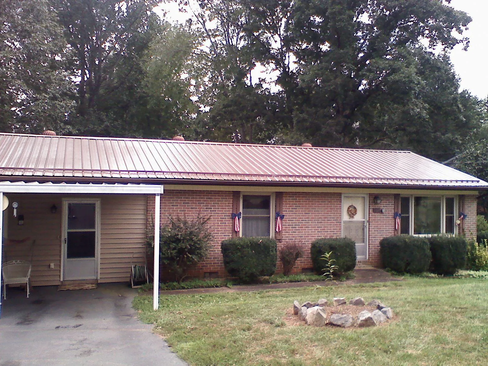 Bronze metal roof and carport on a brick ranch home — Roof Repair work by our crew in Doylestown